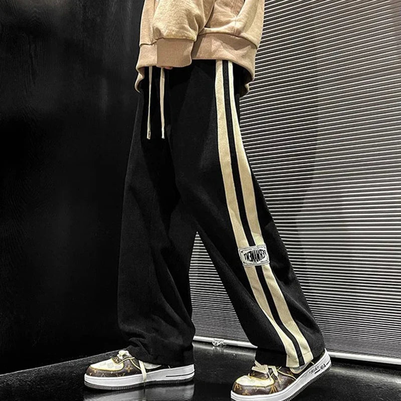 Pantalon large côtelé noir à bande latérale
