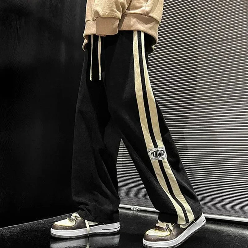 Pantalon large côtelé noir à bande latérale